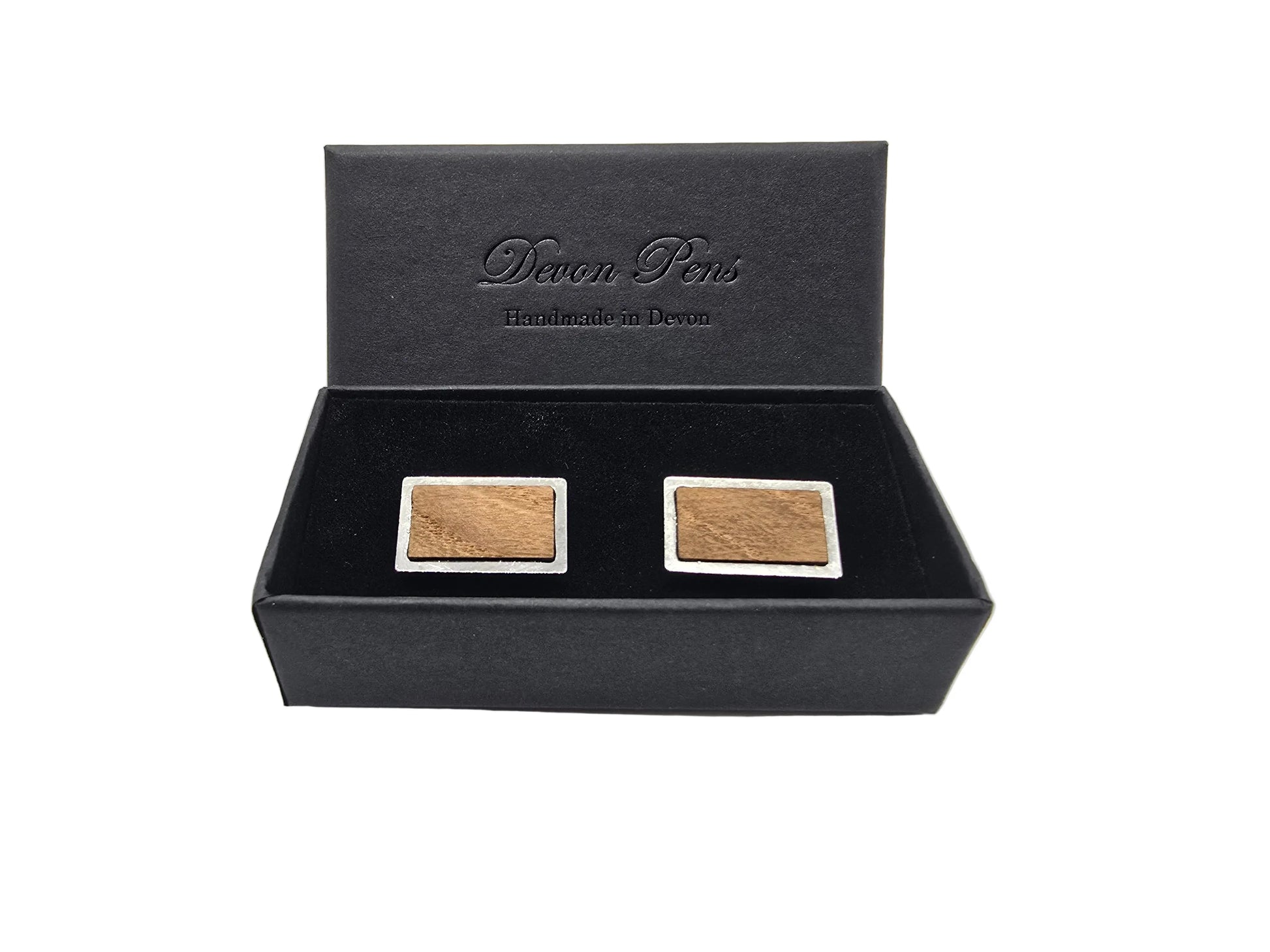 Two square wooden items in a black Devon Pens box on a white background